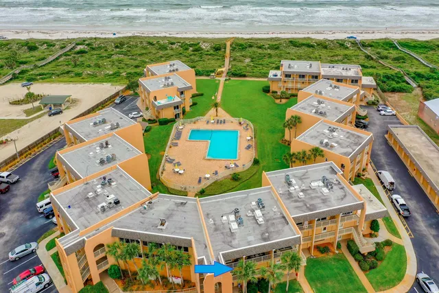 an aerial view of multiple houses with yard