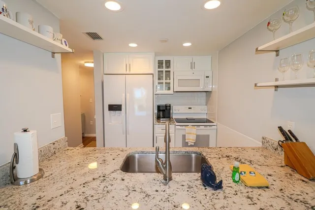 a kitchen with a refrigerator and a stove
