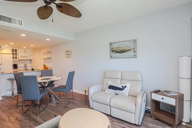 a view of a dining room with furniture and wooden floor