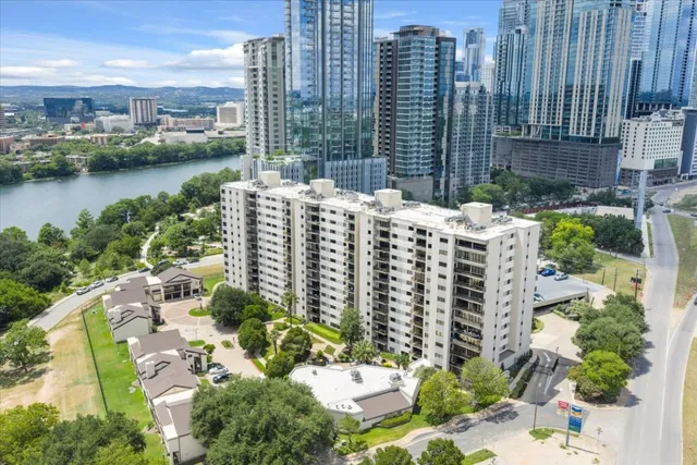 a view of a city with tall buildings and a big yard