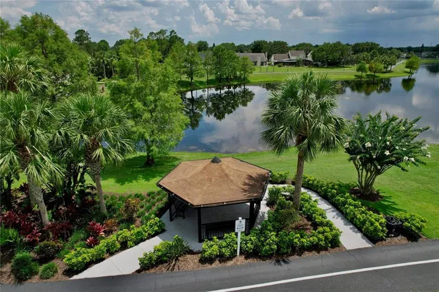 an aerial view of a house with pool garden and lake view