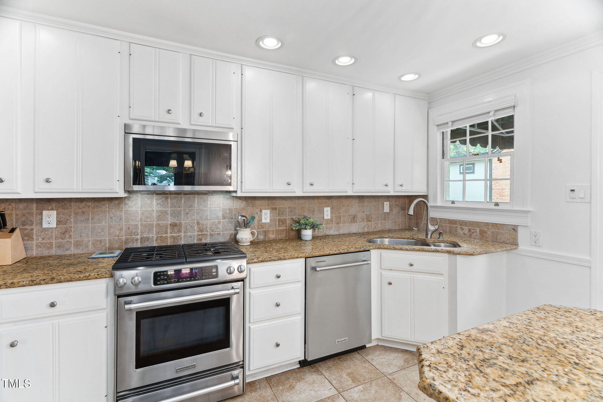 3210 Merriman Avenue Raleigh, NC 27607 - Photo 11 of 43 a kitchen with granite countertop white cabinets and white appliances