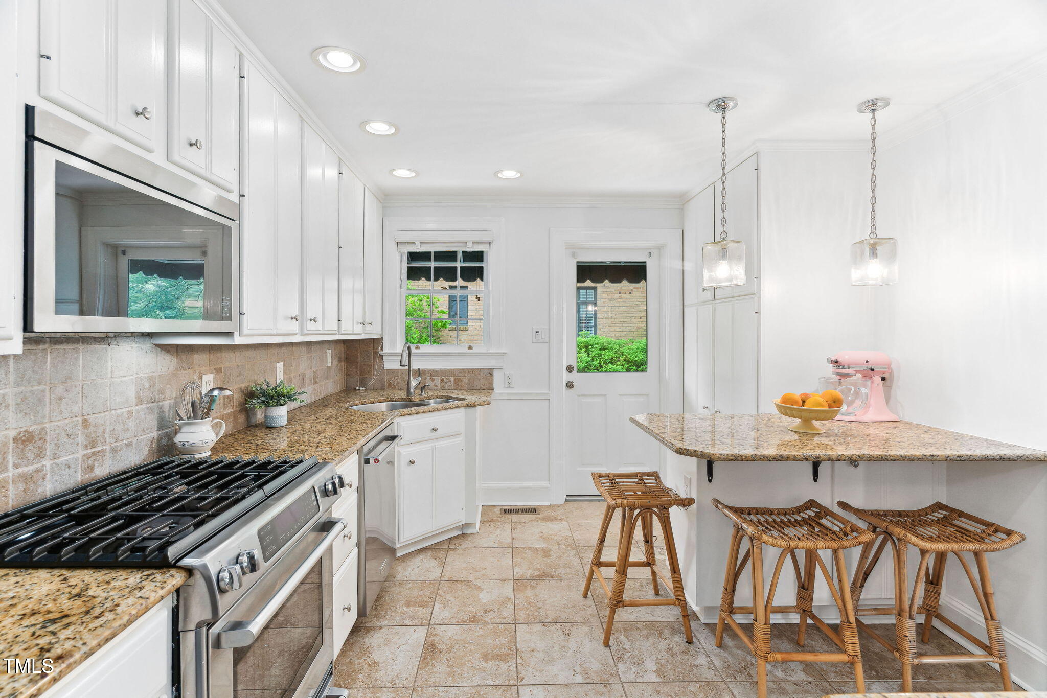 3210 Merriman Avenue Raleigh, NC 27607 - Photo 12 of 43 a kitchen with a sink a stove and cabinets