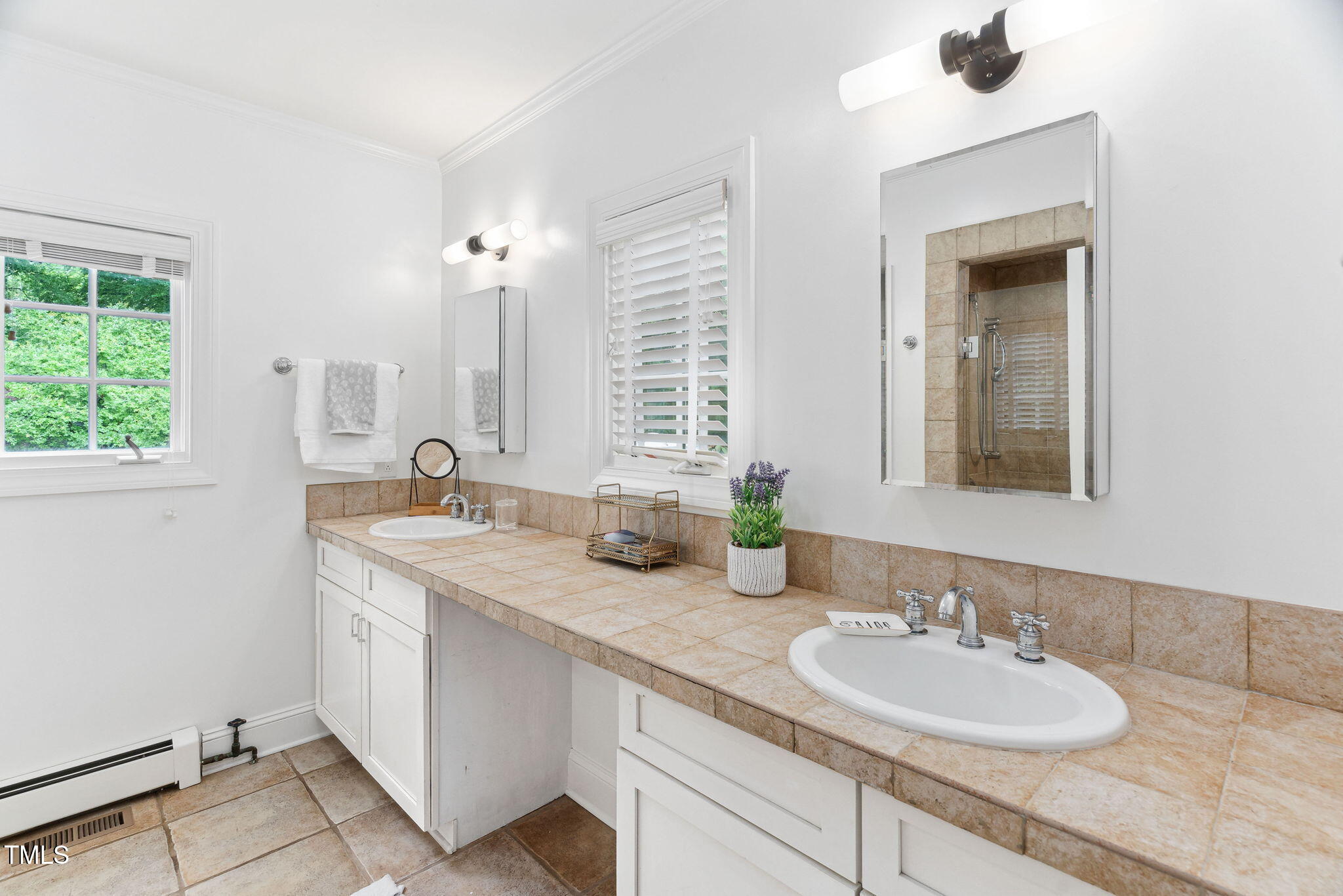 3210 Merriman Avenue Raleigh, NC 27607 - Photo 18 of 43 a bathroom with a granite countertop sink a large mirror and a window