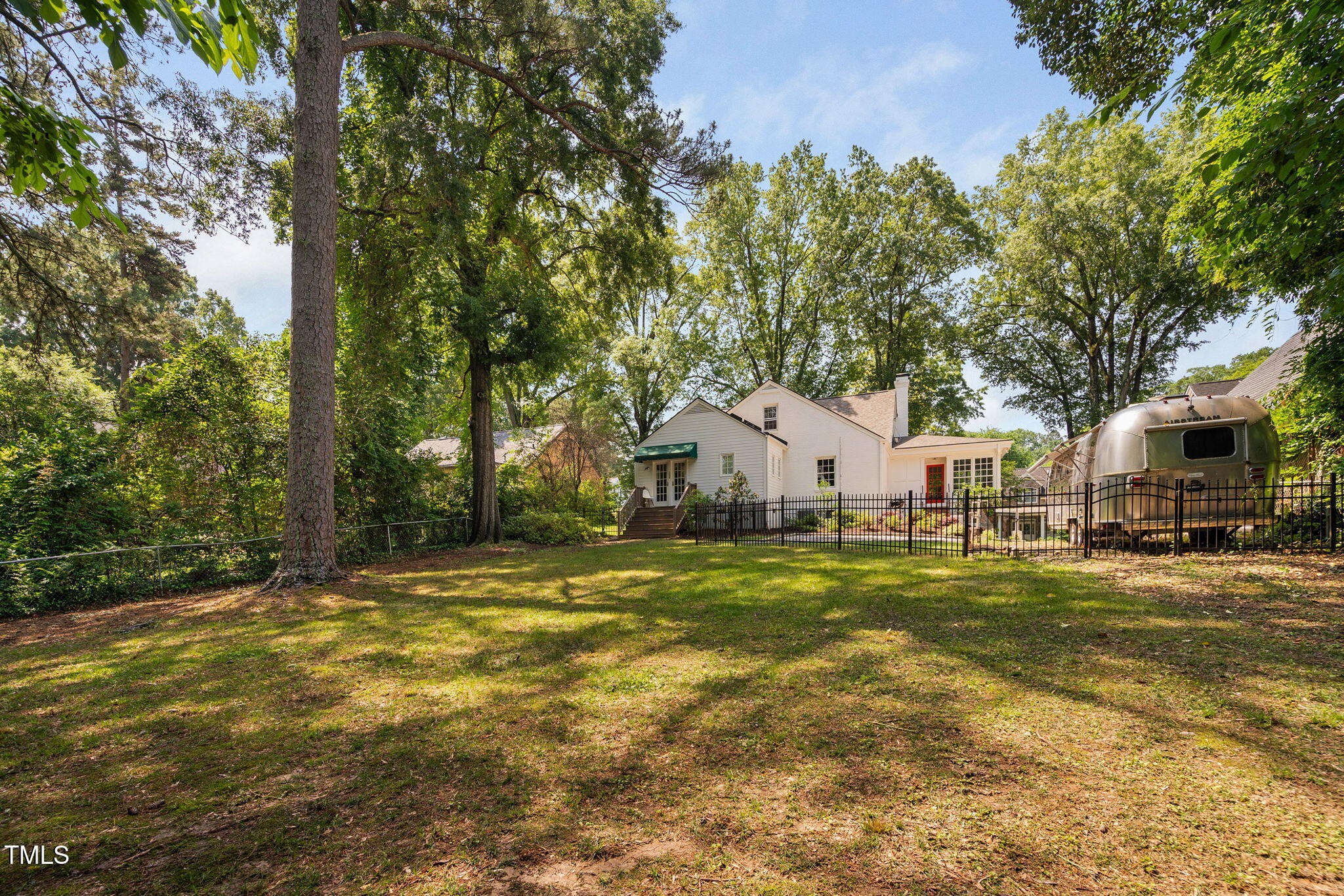 3210 Merriman Avenue Raleigh, NC 27607 - Photo 32 of 43 a yellow house in middle of a forest
