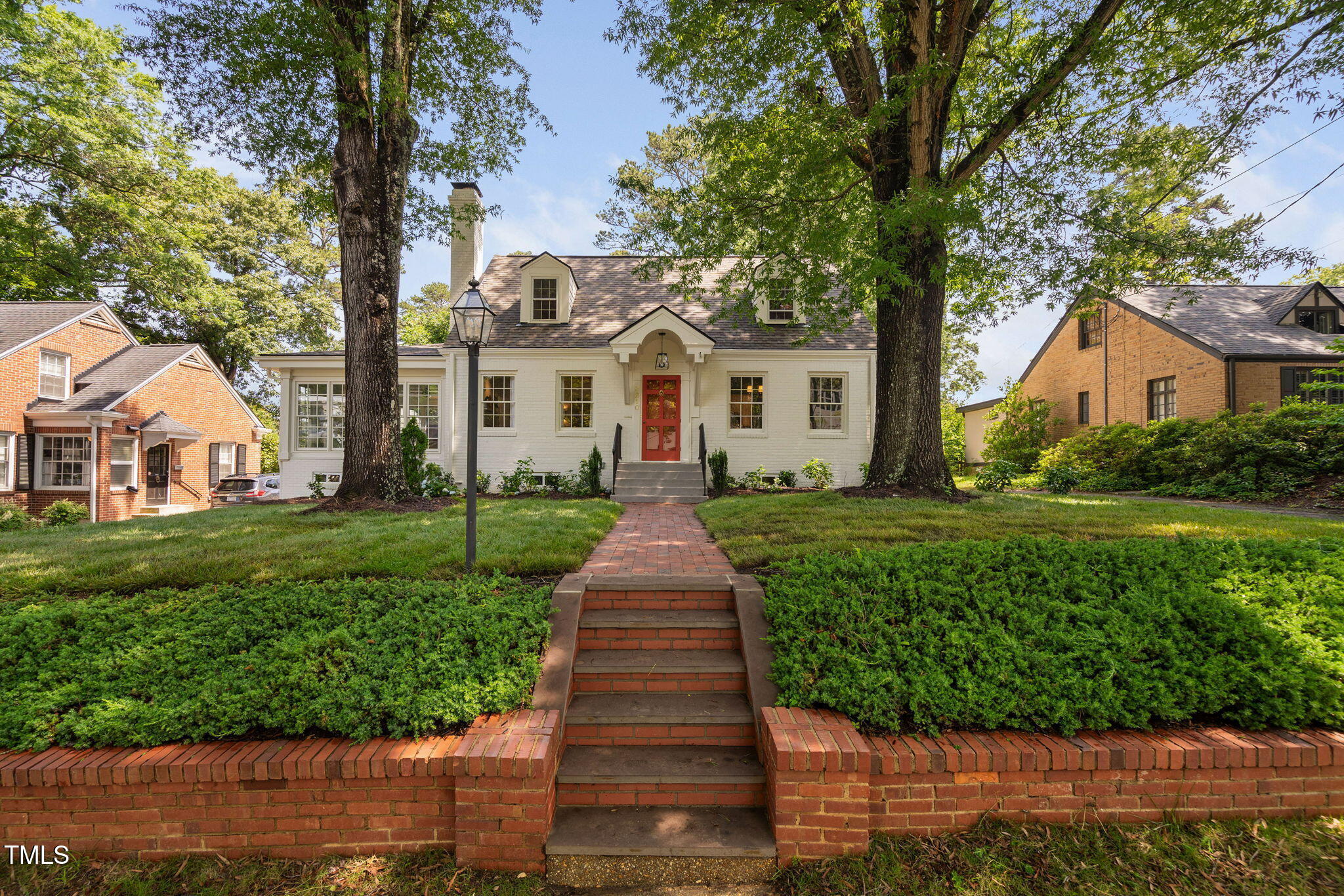 3210 Merriman Avenue Raleigh, NC 27607 - Photo 36 of 43 a front view of a house with a garden and trees