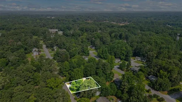 an aerial view of a house with yard