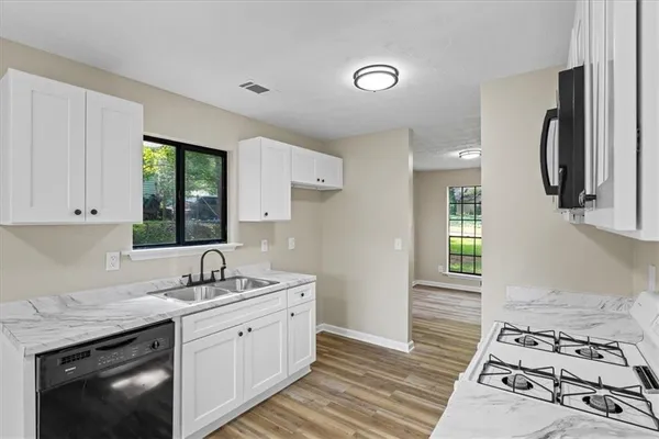 a kitchen with a sink stove and cabinets