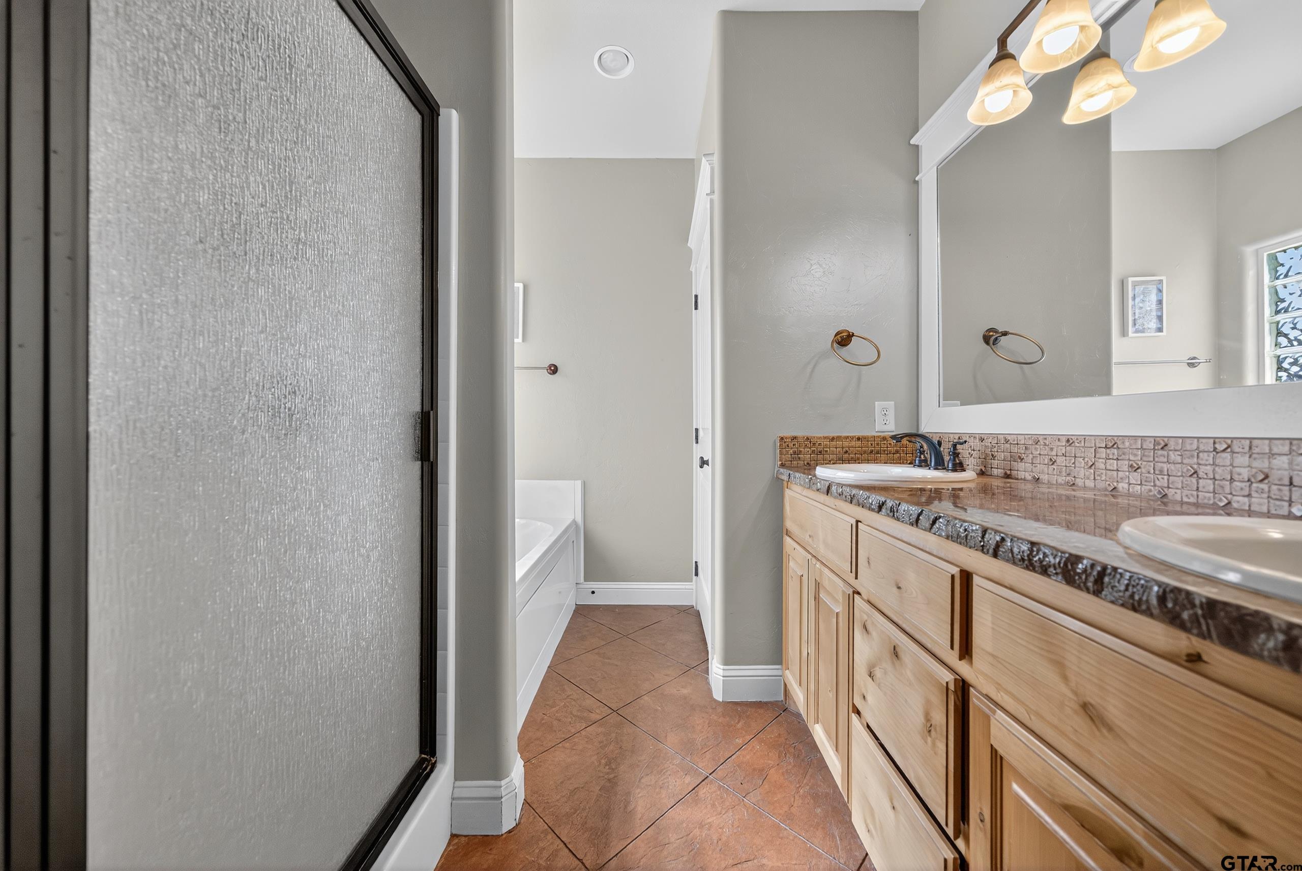 709 Linus Lane Lindale, TX 75771 - Photo 24 of 40 a bathroom with a sink a mirror and a toilet