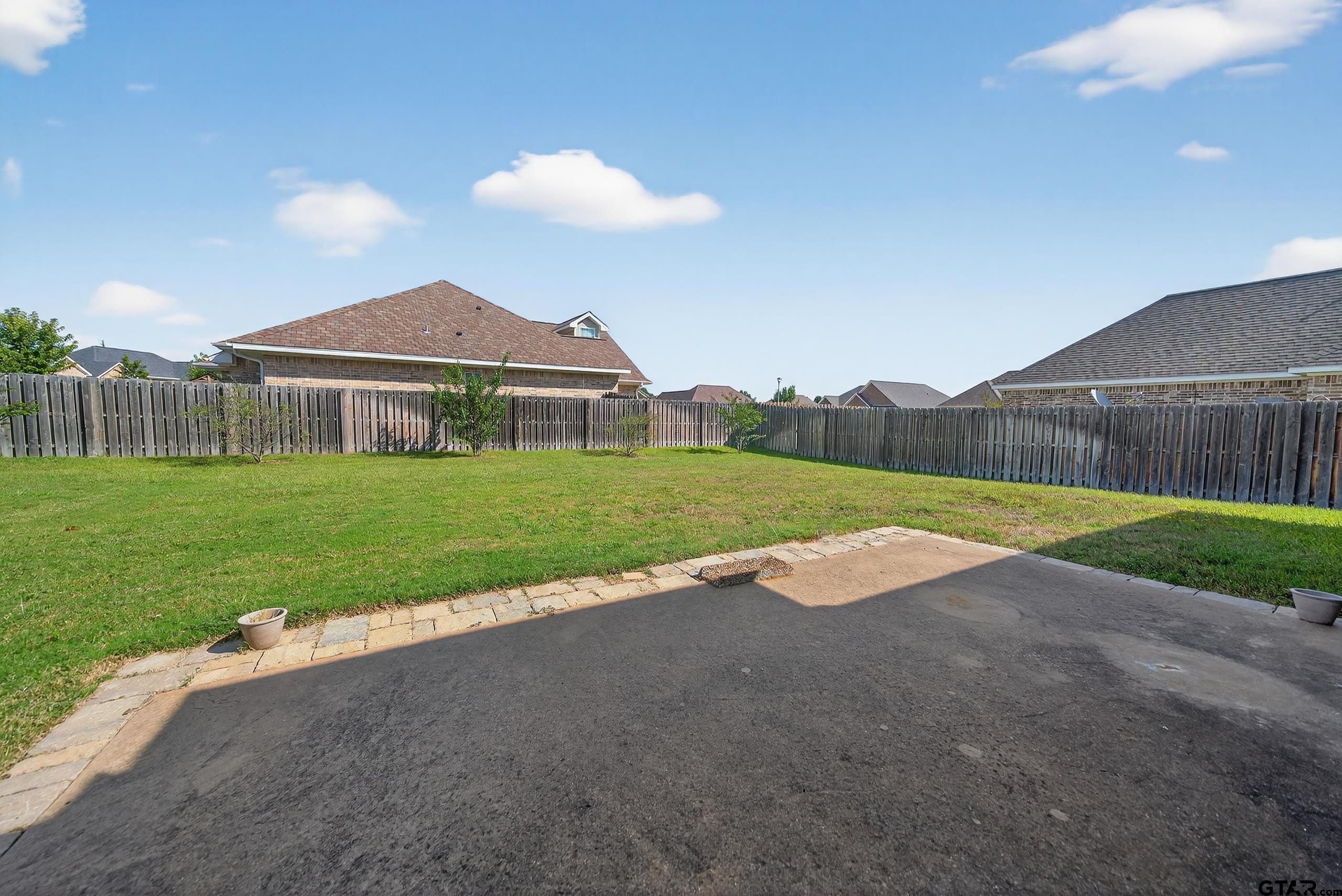 709 Linus Lane Lindale, TX 75771 - Photo 35 of 40 a view of a house with a yard and a patio