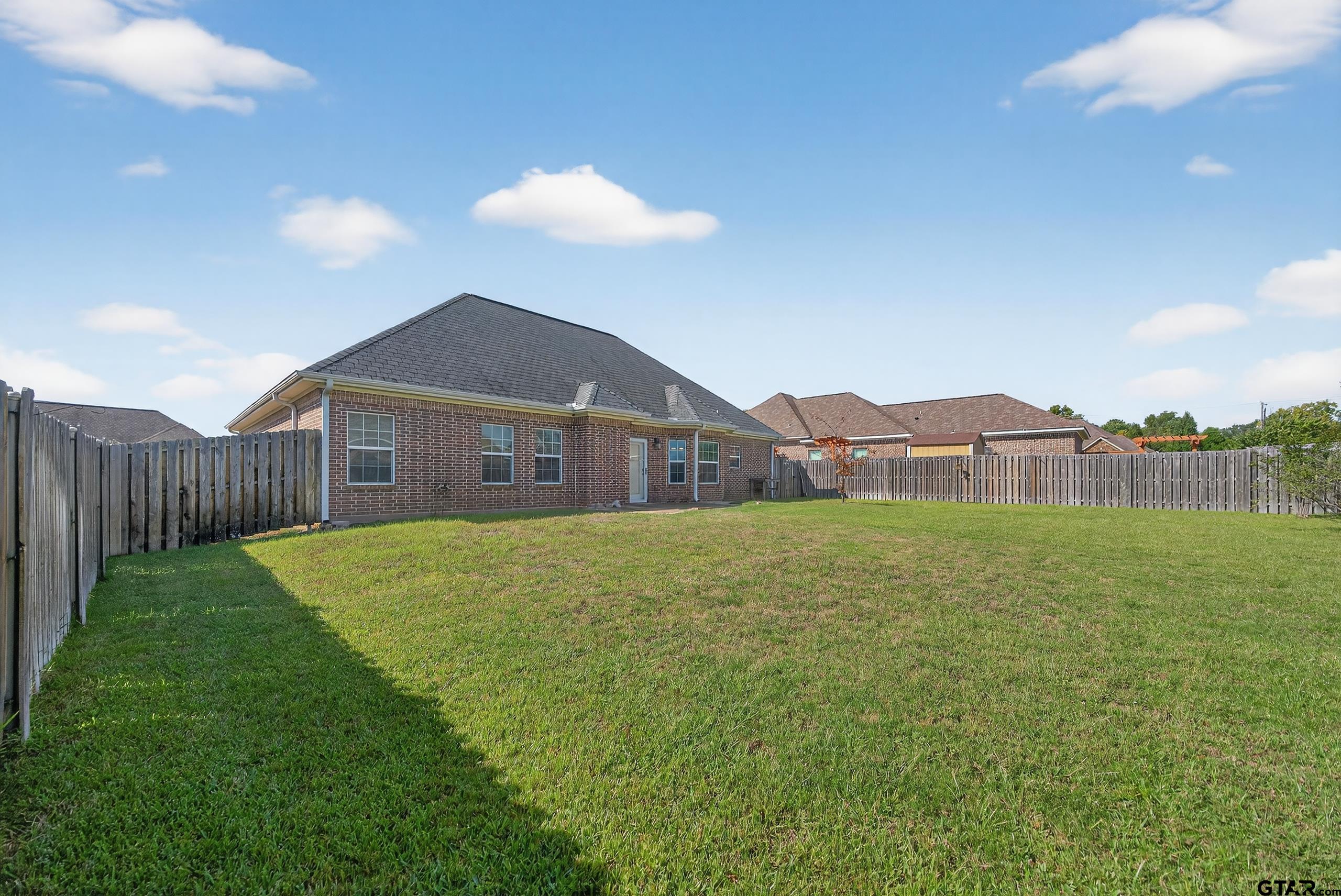 709 Linus Lane Lindale, TX 75771 - Photo 36 of 40 a view of a house with a yard and a large tree