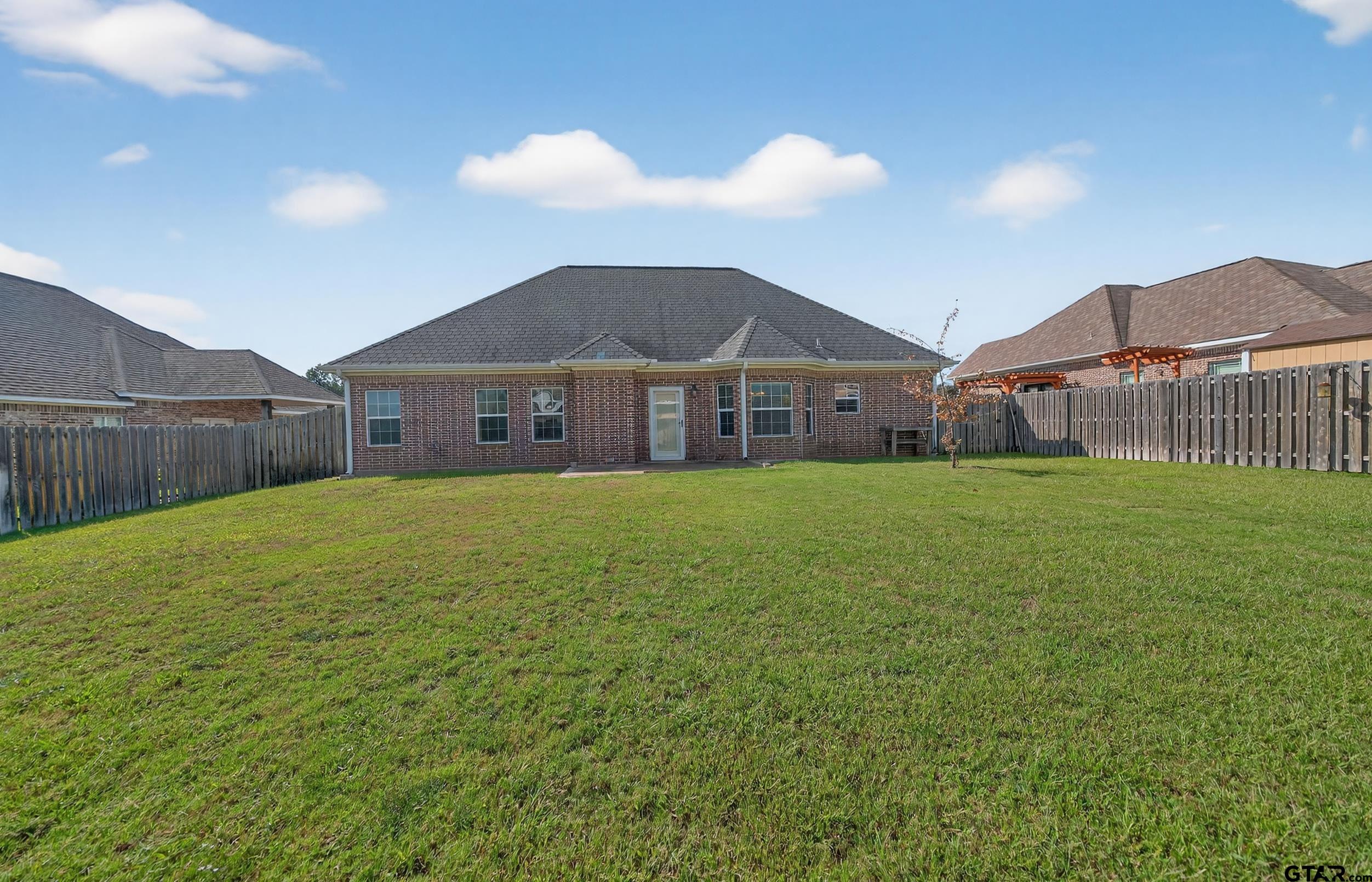 709 Linus Lane Lindale, TX 75771 - Photo 37 of 40 a view of a house with a yard and sitting area