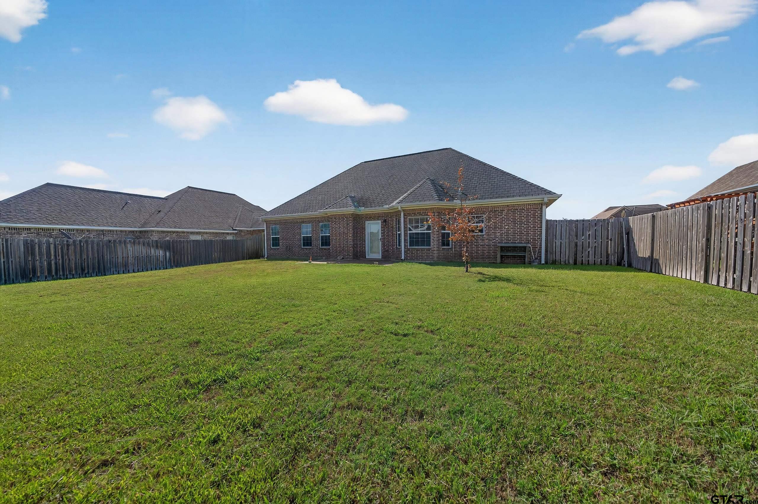 709 Linus Lane Lindale, TX 75771 - Photo 38 of 40 a view of a house with a yard and a large tree