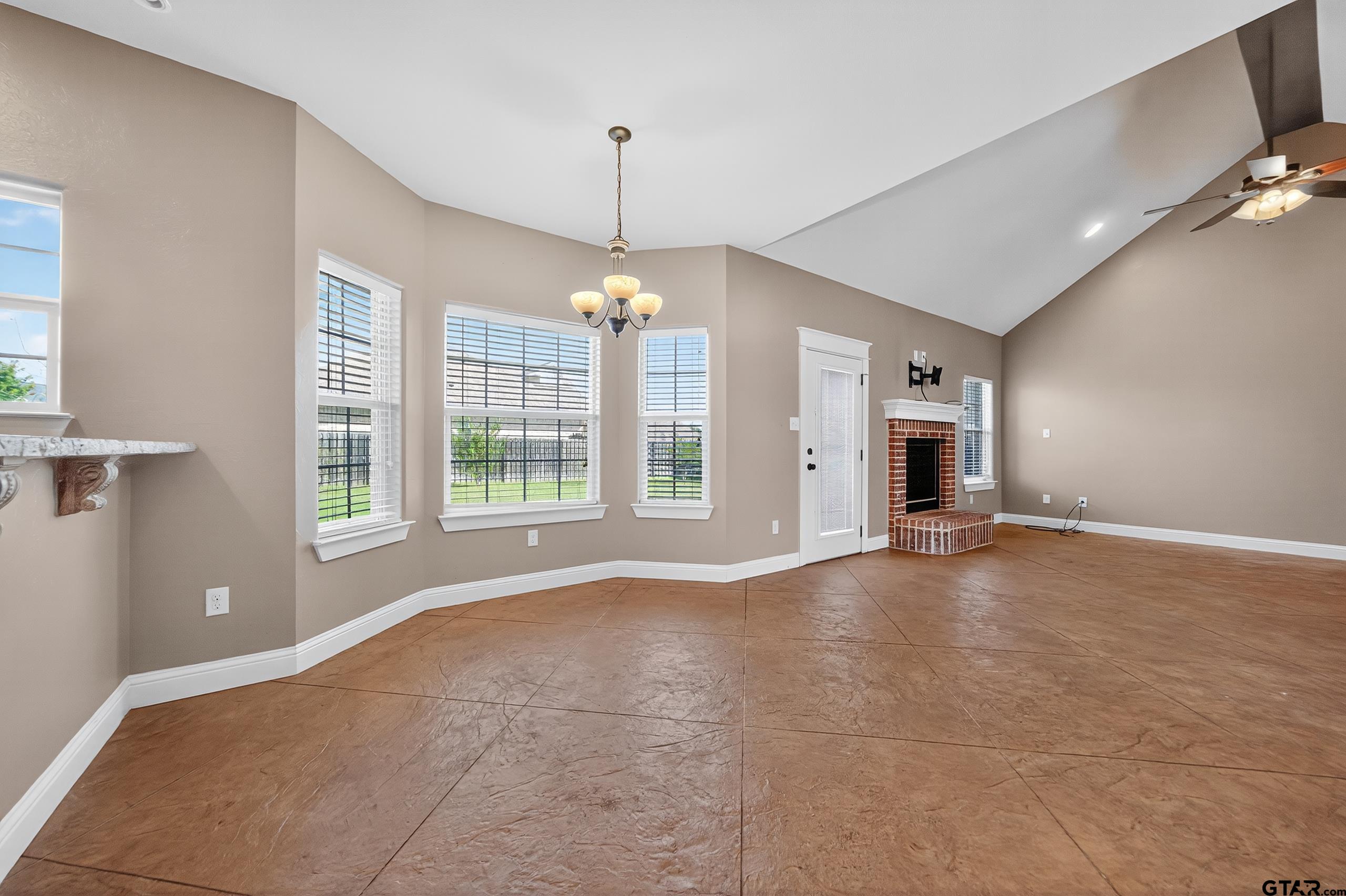 709 Linus Lane Lindale, TX 75771 - Photo 7 of 40 a view of an empty room with a window and chandelier