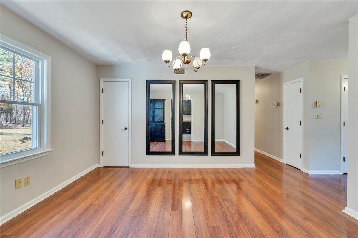 2216 East Ruritan Road Roanoke, VA 24012 - Photo 12 of 57 a view of an empty room with wooden floor and a window