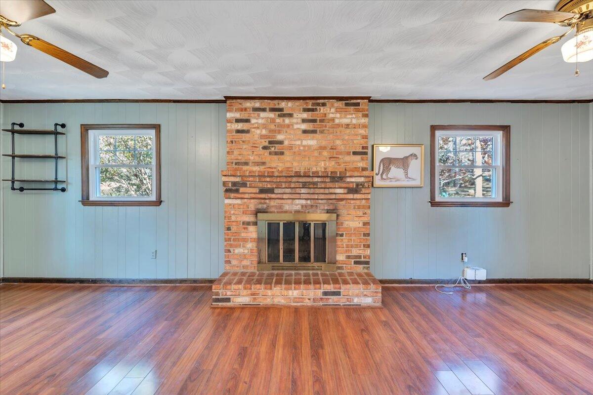 2216 East Ruritan Road Roanoke, VA 24012 - Photo 15 of 57 an empty room with wooden floor fireplace and windows