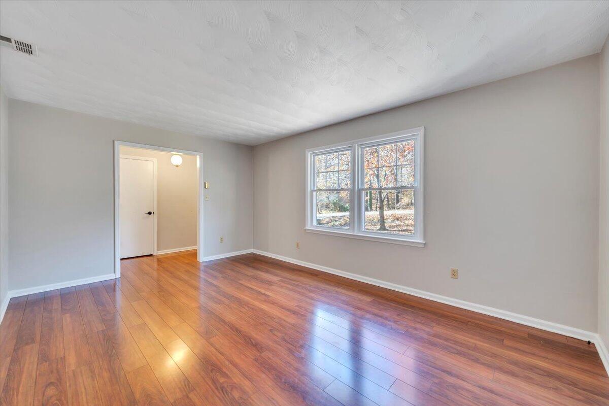 2216 East Ruritan Road Roanoke, VA 24012 - Photo 16 of 57 a view of an empty room with wooden floor and a window