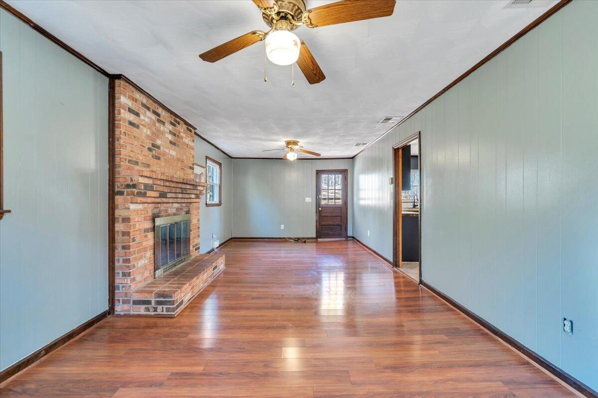 2216 East Ruritan Road Roanoke, VA 24012 - Photo 18 of 57 a view of a livingroom with wooden floor a ceiling fan and staircase