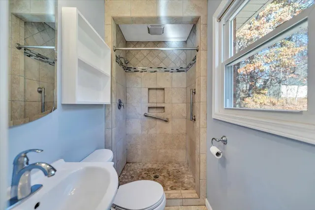 a bathroom with a bath tub with a shower