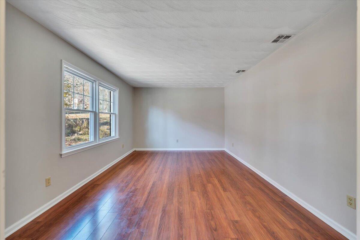 2216 East Ruritan Road Roanoke, VA 24012 - Photo 25 of 57 a view of an empty room with wooden floor and a window