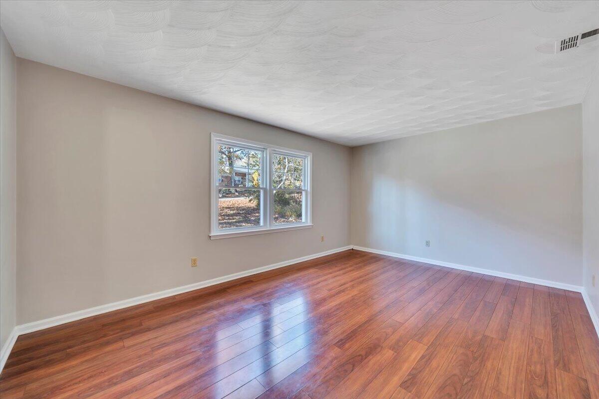 2216 East Ruritan Road Roanoke, VA 24012 - Photo 26 of 57 an empty room with wooden floor and windows