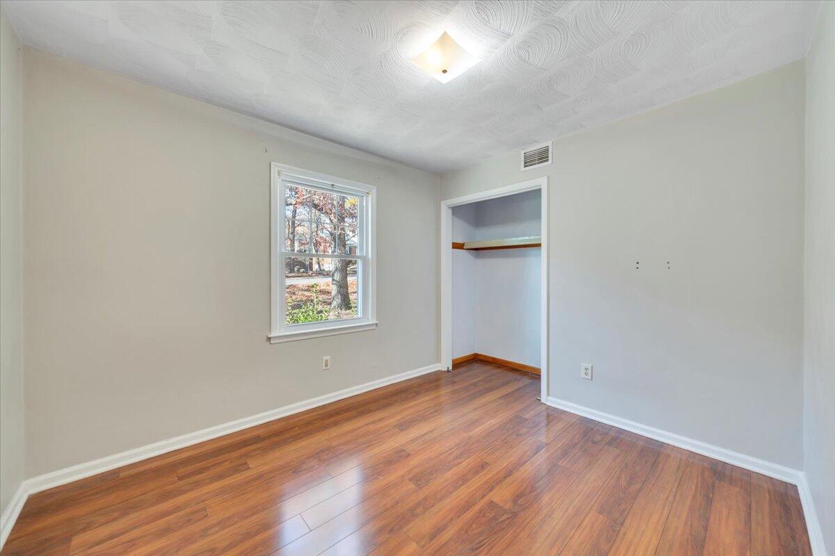 2216 East Ruritan Road Roanoke, VA 24012 - Photo 33 of 57 an empty room with wooden floor and windows
