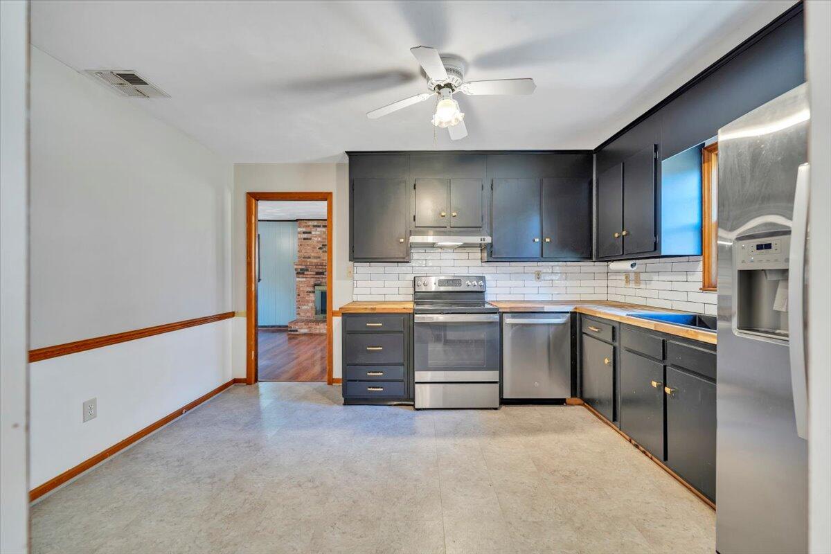 2216 East Ruritan Road Roanoke, VA 24012 - Photo 6 of 57 a kitchen with stainless steel appliances a stove a sink dishwasher a refrigerator with a dining table and chairs