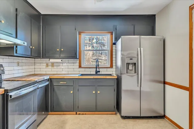 a kitchen with stainless steel appliances a refrigerator and a sink