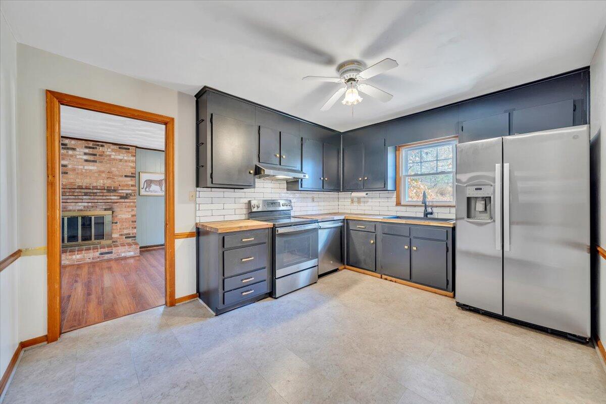 2216 East Ruritan Road Roanoke, VA 24012 - Photo 10 of 57 a kitchen with a refrigerator a sink and dishwasher with a large window