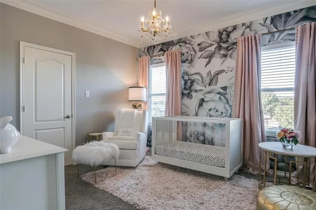 a bedroom with a bed and a chandelier