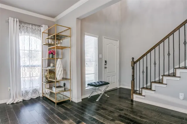 a view of entryway with wooden floor and stairs