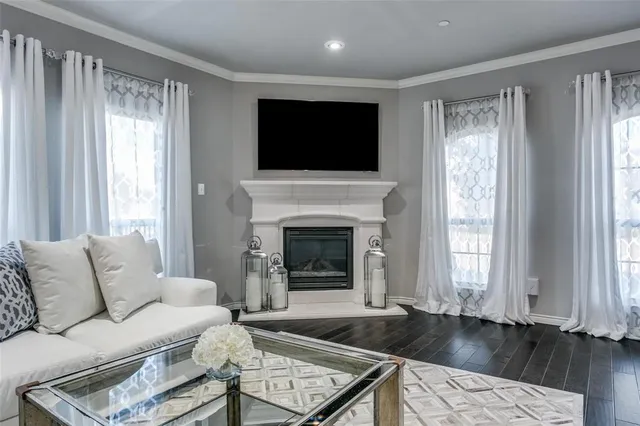 a living room with furniture fireplace and flat screen tv