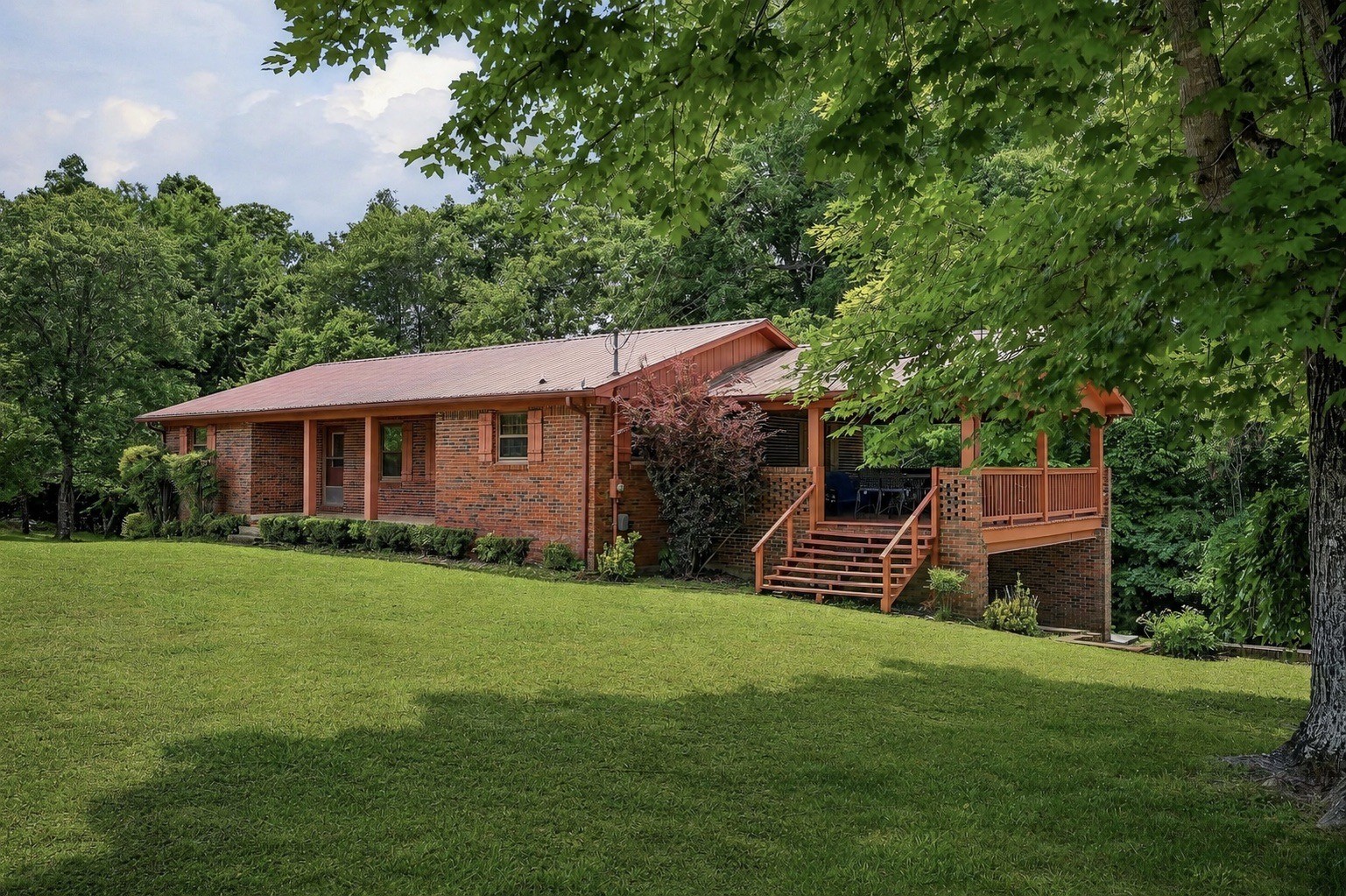 a front view of a house with a garden