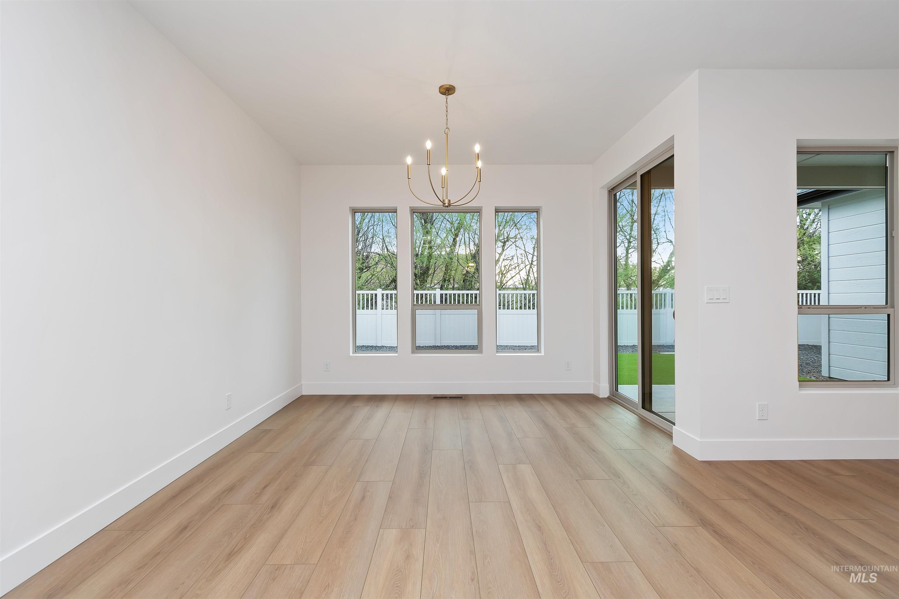 4302 Tropic Way Caldwell, ID 83607 - Photo 13 of 32 Unfurnished dining area with a chandelier and light wood finished floors