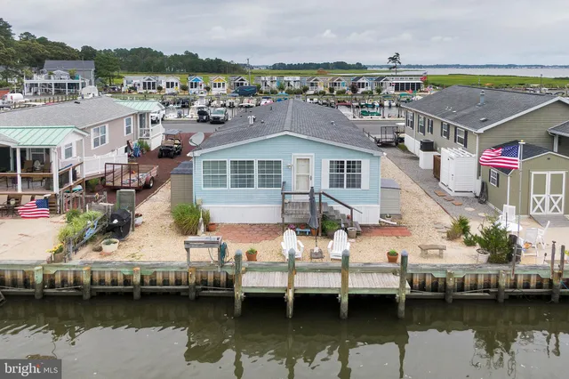 a view of residential houses with outdoor space and lake view