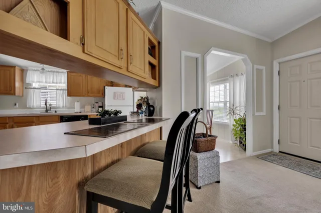 a view of a livingroom with workspace and a window