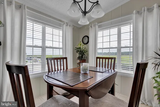a view of a livingroom with workspace and a window