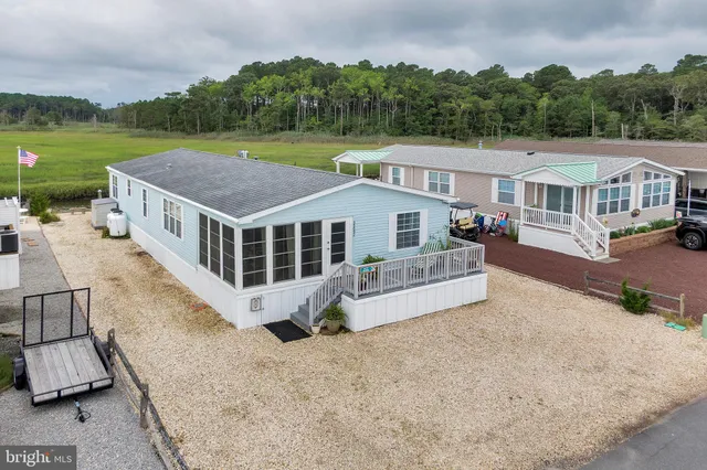 a view of residential houses with outdoor space and lake view