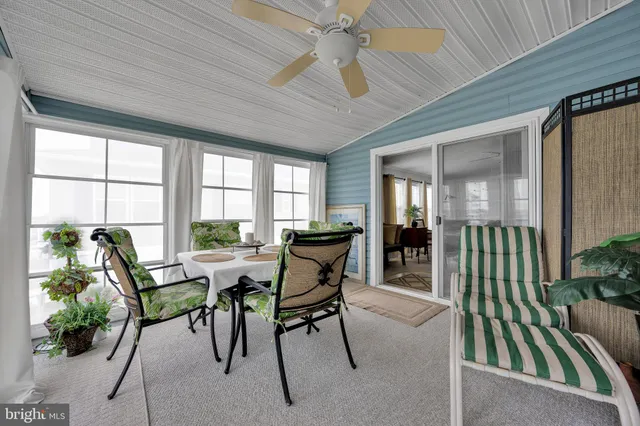 a backyard of a house with barbeque oven table and chairs