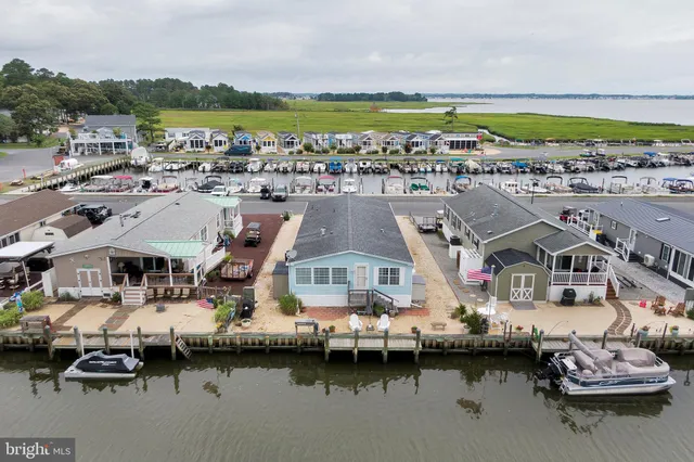 a backyard of a house with barbeque oven table and chairs