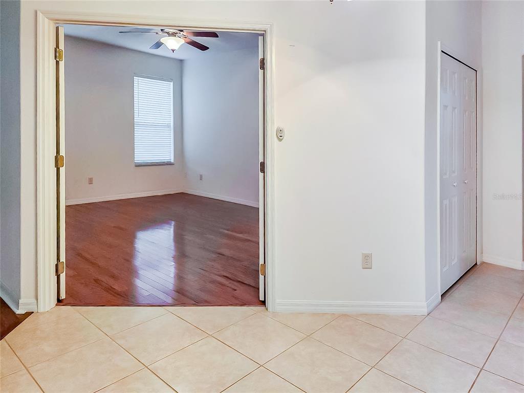 16299 Southwest 14th Avenue Road Ocala, FL 34473 - Photo 16 of 50 an empty room with wooden floor and windows