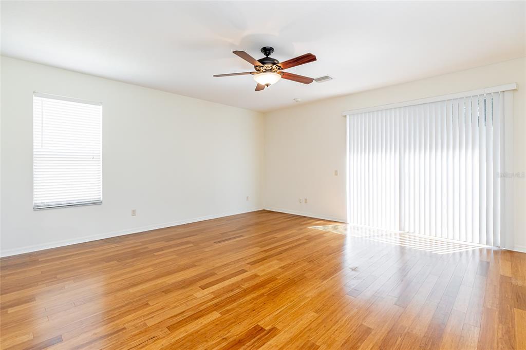 16299 Southwest 14th Avenue Road Ocala, FL 34473 - Photo 20 of 50 wooden floor in an empty room with a window
