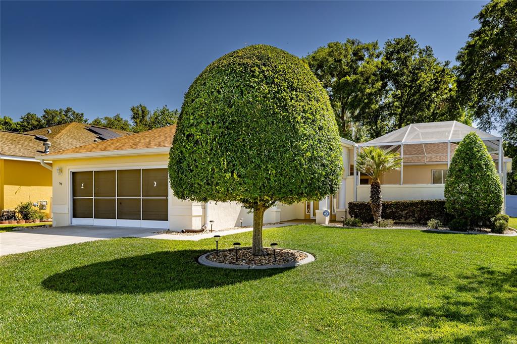 16299 Southwest 14th Avenue Road Ocala, FL 34473 - Photo 2 of 50 a front view of a house with a yard