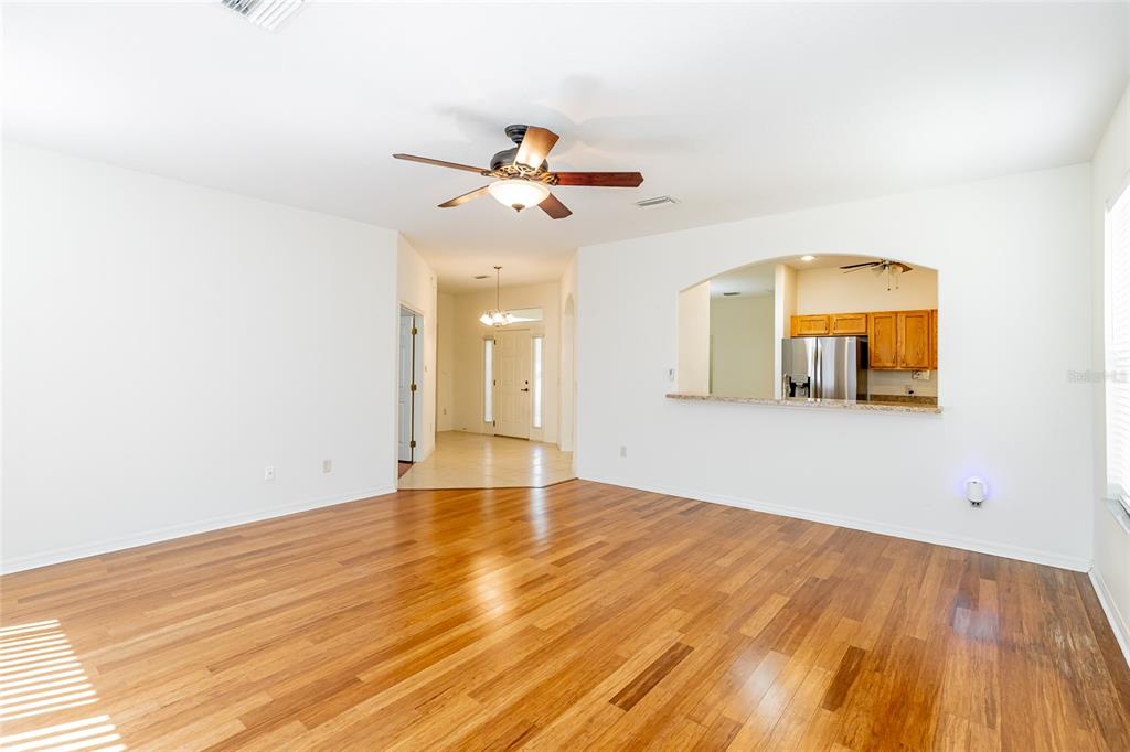 16299 Southwest 14th Avenue Road Ocala, FL 34473 - Photo 22 of 50 a view of a room with wooden floor and ceiling fan