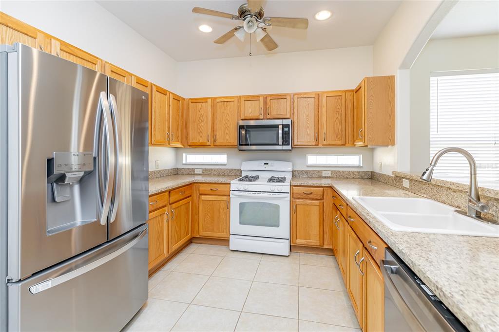 16299 Southwest 14th Avenue Road Ocala, FL 34473 - Photo 24 of 50 a kitchen with a sink stove and refrigerator