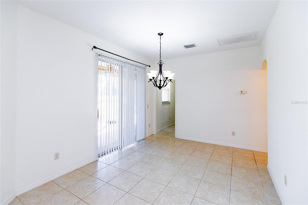 16299 Southwest 14th Avenue Road Ocala, FL 34473 - Photo 25 of 50 a view of an empty room with chandelier fan