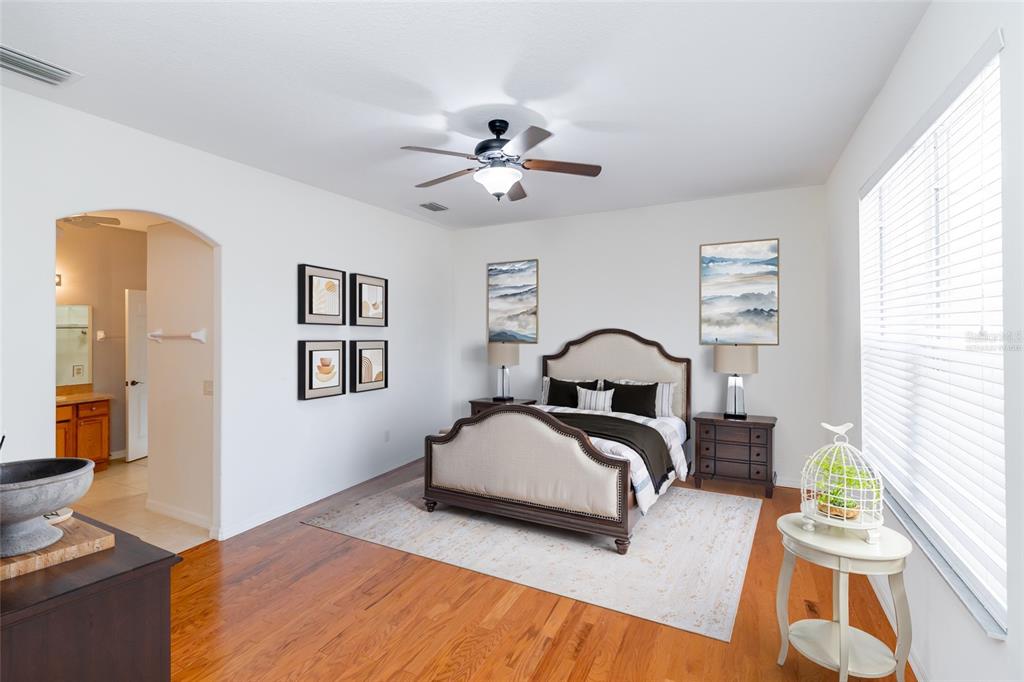 16299 Southwest 14th Avenue Road Ocala, FL 34473 - Photo 29 of 50 a bedroom with a bed and wooden floor