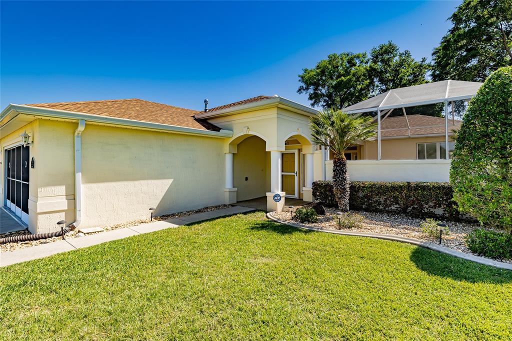 16299 Southwest 14th Avenue Road Ocala, FL 34473 - Photo 3 of 50 a front view of a house with swimming pool and porch
