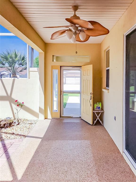 16299 Southwest 14th Avenue Road Ocala, FL 34473 - Photo 9 of 50 a view of a bedroom with wooden floor and a ceiling fan