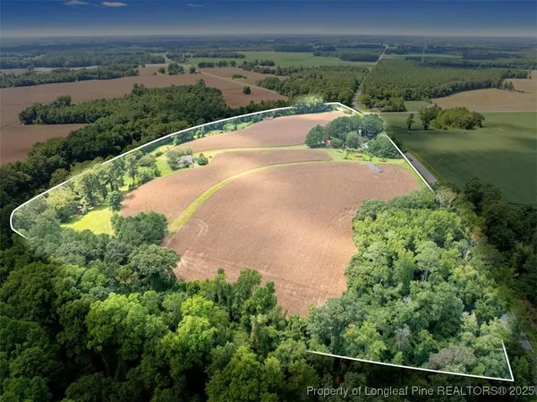 an aerial view of a house with a yard and lake view